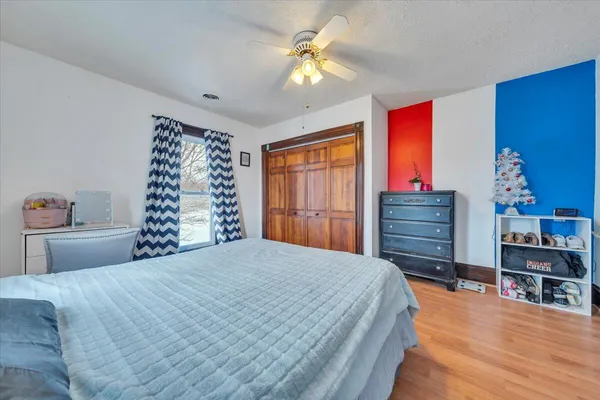a bedroom with bed and a chandelier
