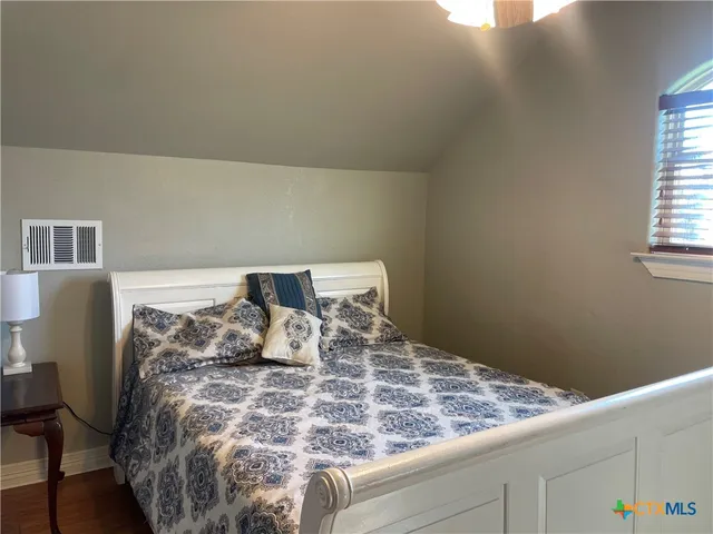 a bed sitting in a bedroom next to a window