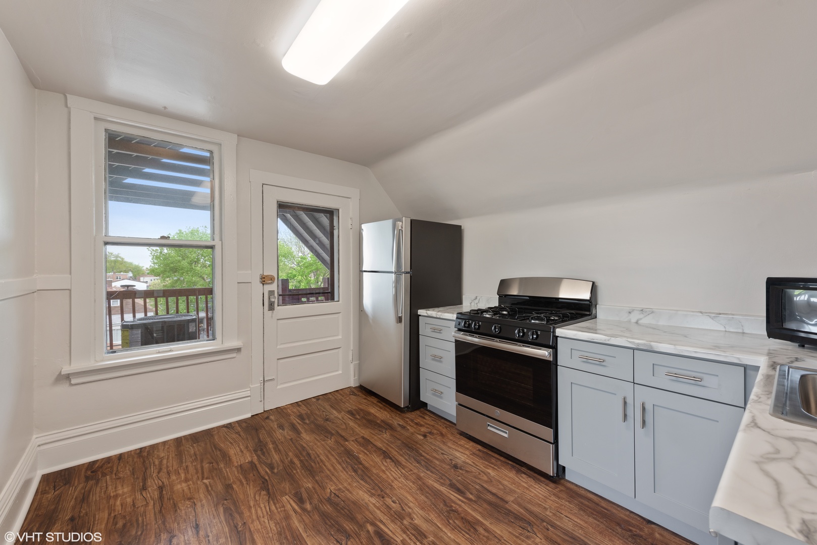 Undisclosed Address Chicago, IL 60630 - Photo 4 of 7 a kitchen with a stove a sink and a microwave