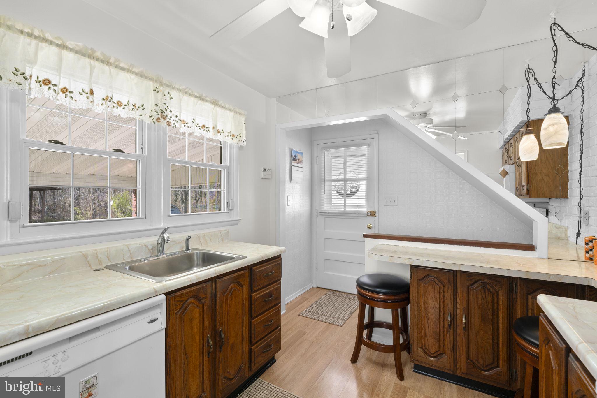 943 Homberg Avenue Baltimore, MD 21221 - Photo 11 of 34 a kitchen with a sink cabinets and window