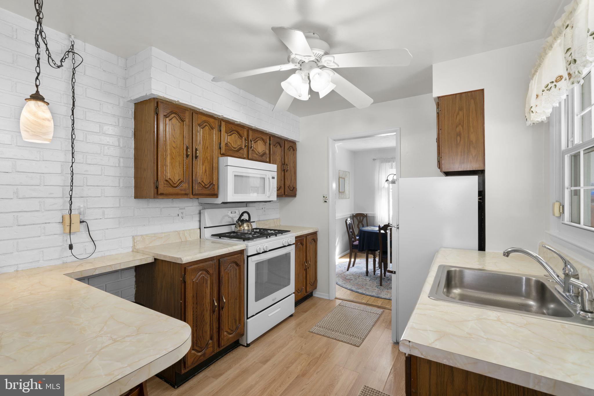 943 Homberg Avenue Baltimore, MD 21221 - Photo 13 of 34 a kitchen with a stove a sink and a refrigerator