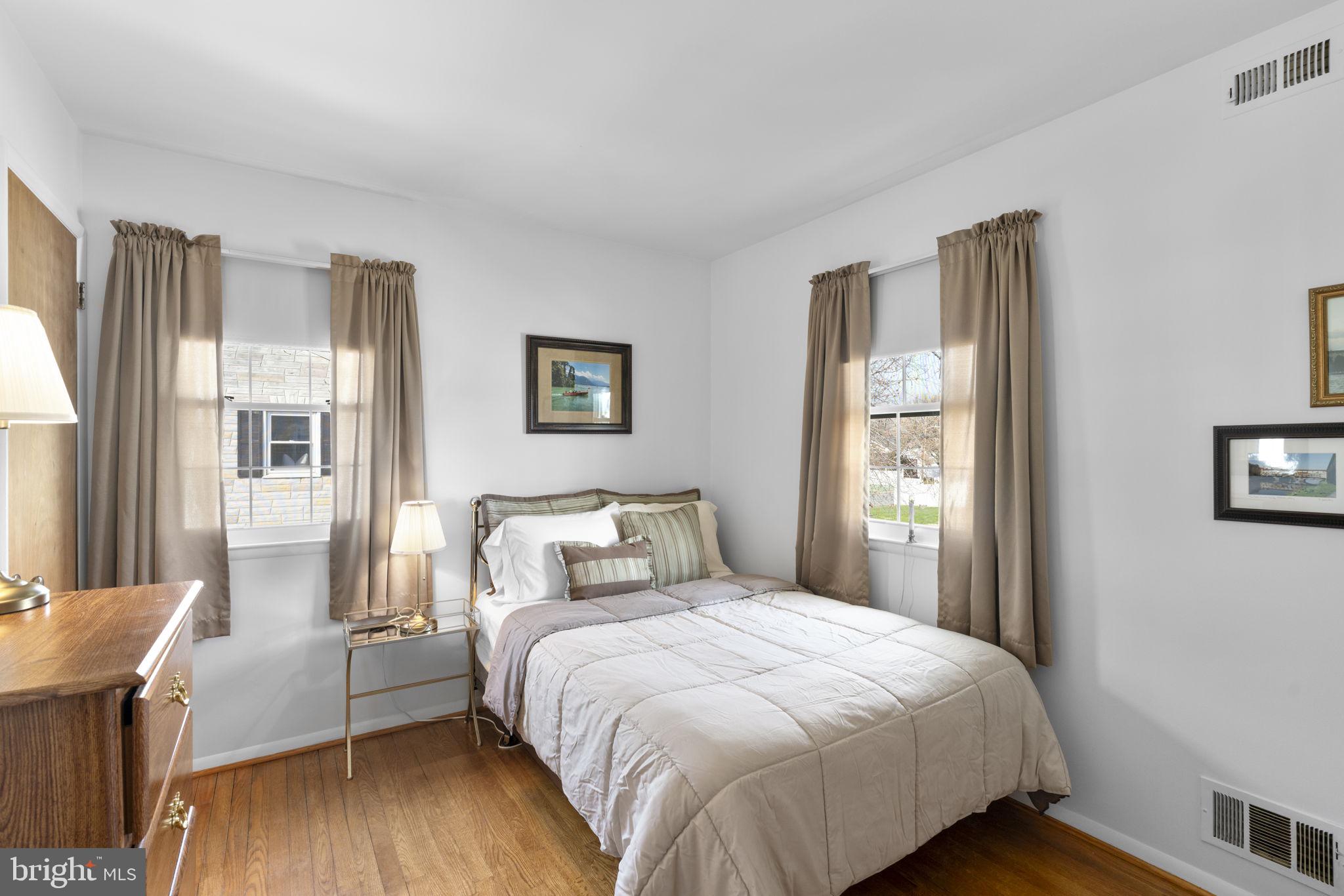 943 Homberg Avenue Baltimore, MD 21221 - Photo 15 of 34 a bedroom with a bed and wooden floor