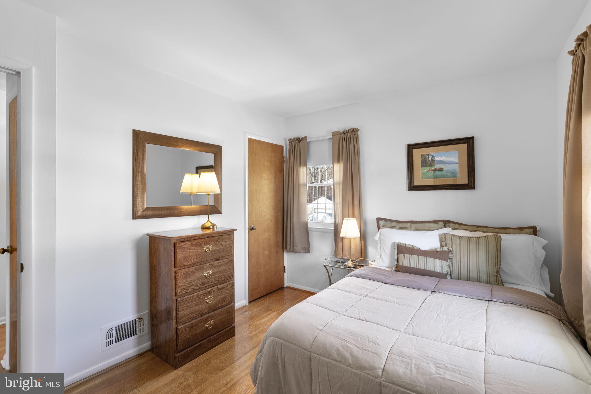 943 Homberg Avenue Baltimore, MD 21221 - Photo 16 of 34 a bedroom with a bed and a flat screen tv