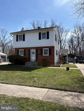 a front view of a house with a garden and yard