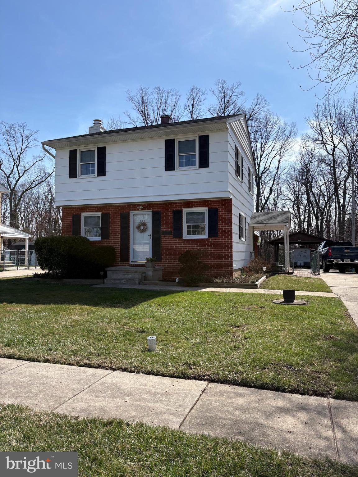 943 Homberg Avenue Baltimore, MD 21221 - Photo 2 of 2 a front view of a house with a garden and yard
