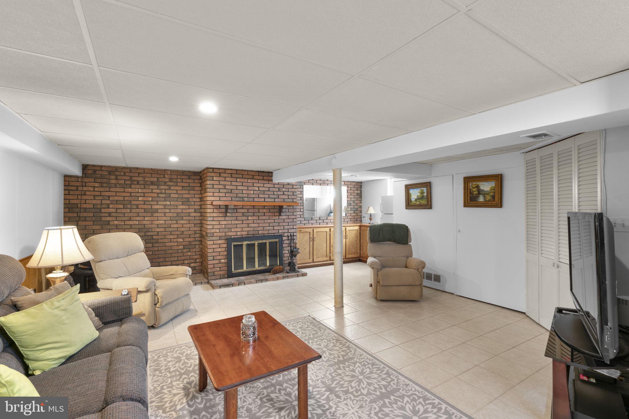 943 Homberg Avenue Baltimore, MD 21221 - Photo 24 of 34 a living room with fireplace furniture and a flat screen tv