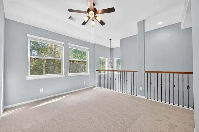 a view of a livingroom with a ceiling fan and window