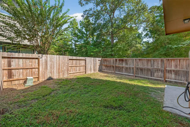 a view of a house with a yard and sitting area