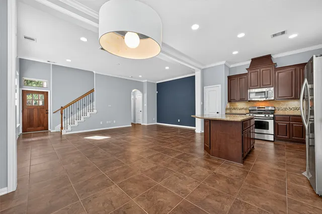 a view of kitchen with kitchen island microwave and stove