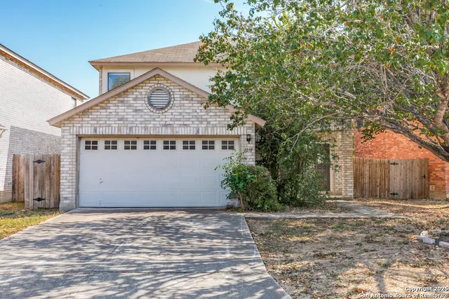 a view of a house with a yard and garage