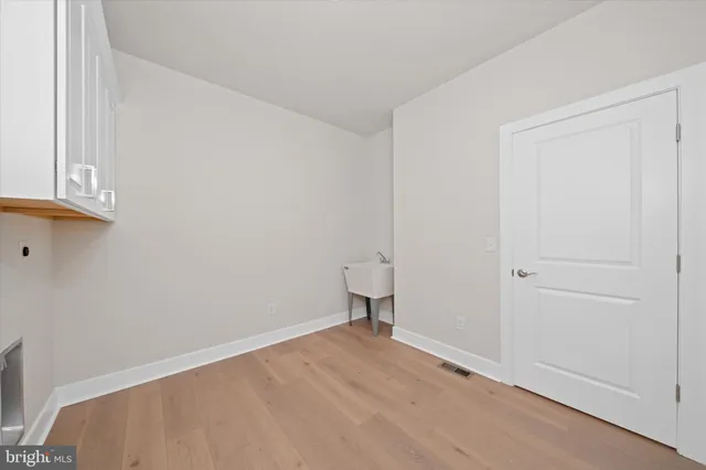 a view of an empty room and wooden floor