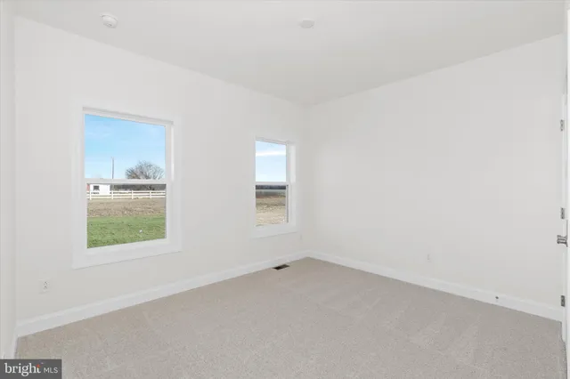 a bedroom with a bed couch and window