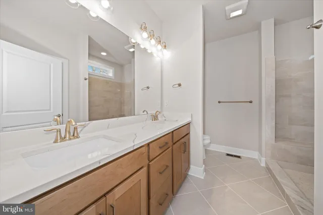 a view of an empty room with a window and fireplace