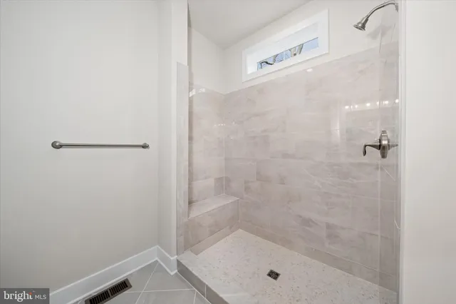 a view of an empty room with a fireplace and a window