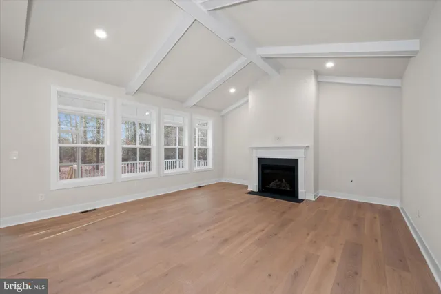 a large kitchen with white cabinets stainless steel appliances a sink and kitchen island