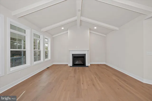 a view of a kitchen with kitchen island a sink stainless steel appliances and cabinets