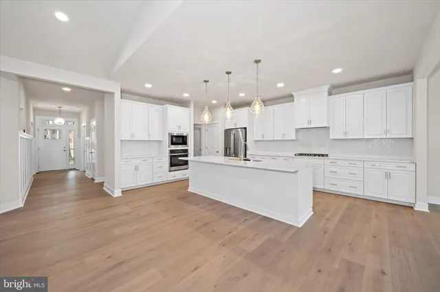a kitchen with stainless steel appliances a refrigerator sink and cabinets