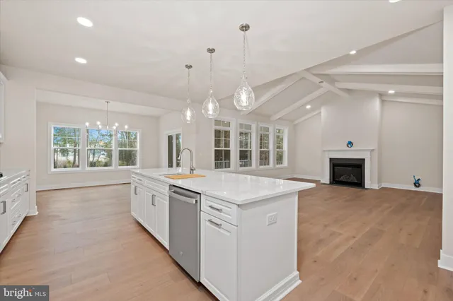 a view of kitchen with kitchen island white cabinets and refrigerator