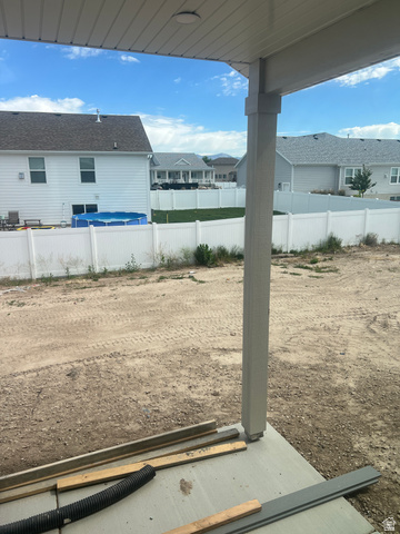 4740 West 25 North West Point, UT 84015 - Photo 12 of 15 Covered patio space featuring a concrete slab and a white vinyl privacy fence