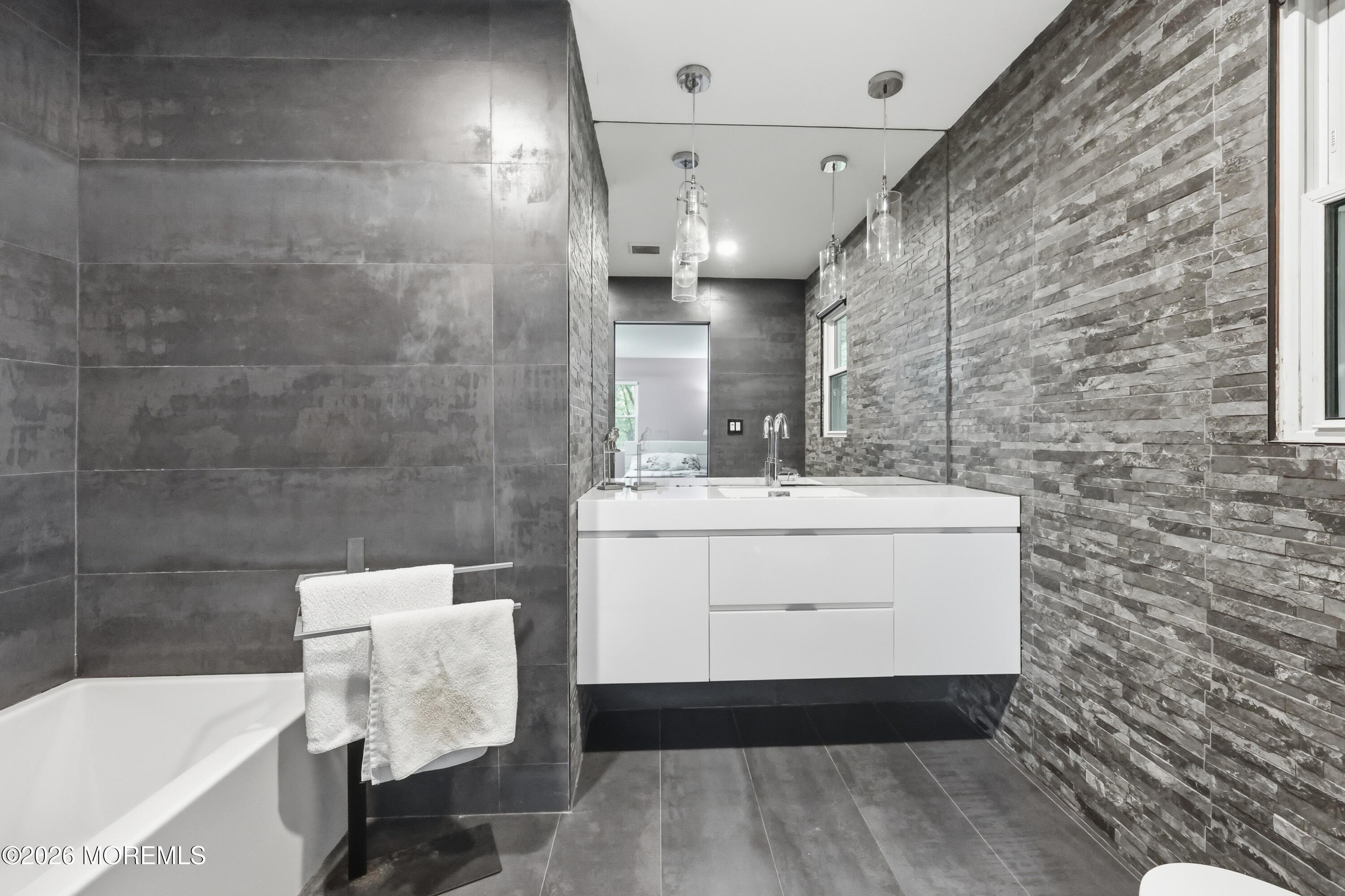 1845 Old Freehold Road Toms River, NJ 08755 - Photo 17 of 27 a bathroom with a sink a mirror and a bathtub