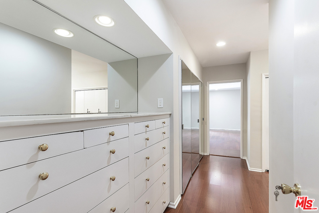 711 Sierra Drive Beverly Hills, CA 90210 - Photo 23 of 40 a bathroom with a sink and a mirror