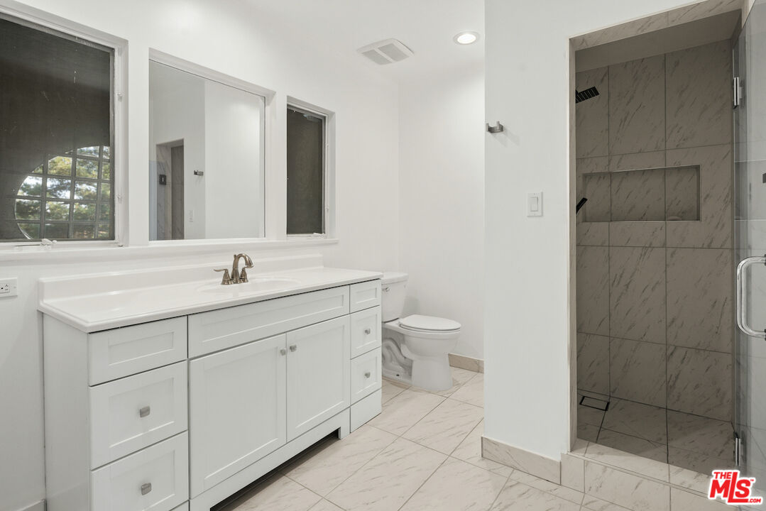 711 Sierra Drive Beverly Hills, CA 90210 - Photo 35 of 40 a bathroom with a toilet sink and shower