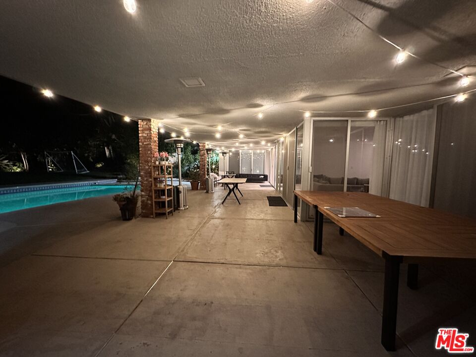 711 Sierra Drive Beverly Hills, CA 90210 - Photo 40 of 40 a group of people sitting in a room