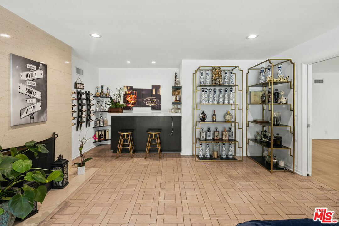 711 Sierra Drive Beverly Hills, CA 90210 - Photo 9 of 40 a living room with furniture a window and bookshelf