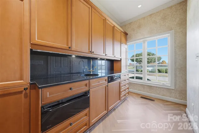 a bathroom with a granite countertop sink mirror and a bathtub