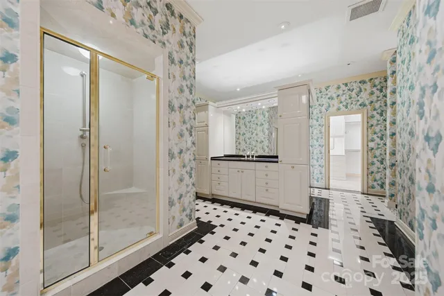 a bathroom with a glass shower door