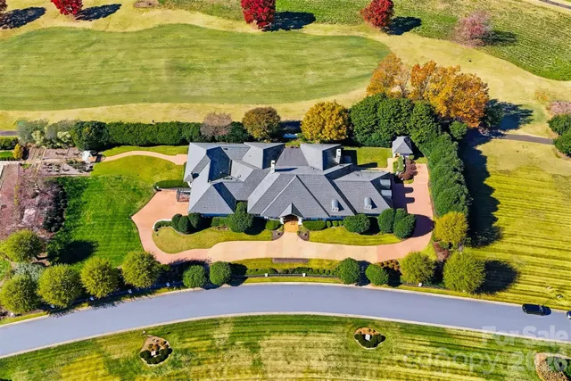 a view of a dining room with furniture and a chandelier