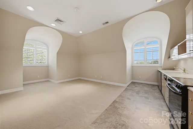 a kitchen with stainless steel appliances a stove a microwave and a window
