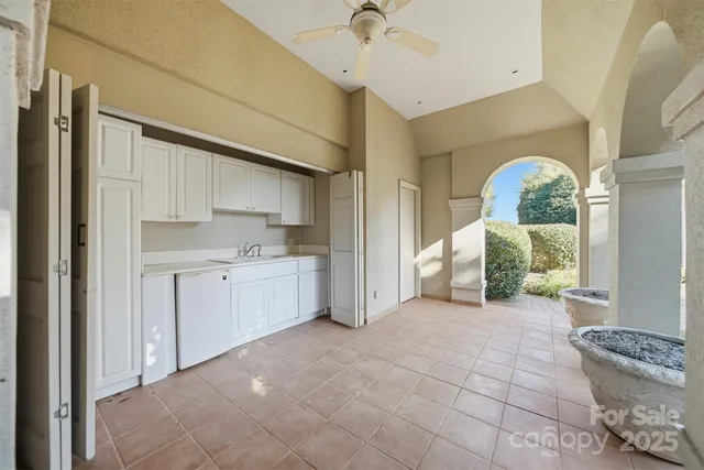 an aerial view of a house with a garden and swimming pool