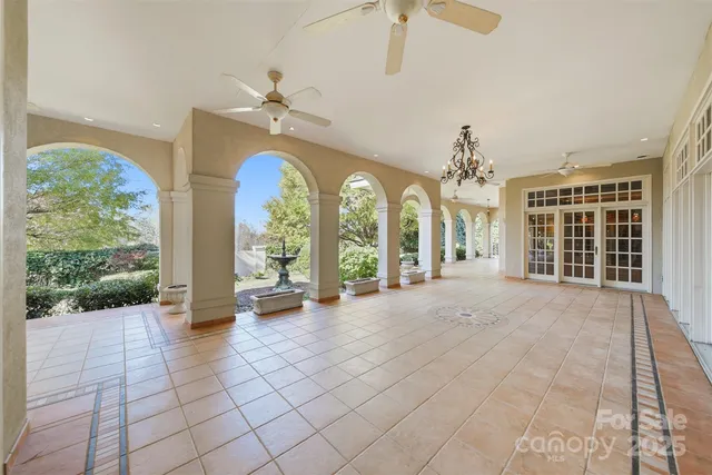 a view of a room with a large window and chandelier