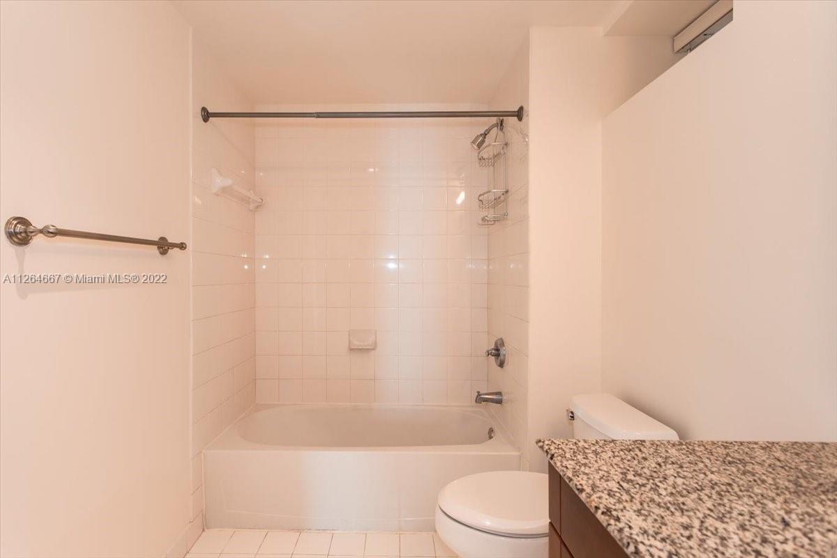 7275 Southwest 90th Street, Unit C310 Miami, FL 33156 - Photo 16 of 40 a bathroom with a bathtub shower sink and toilet