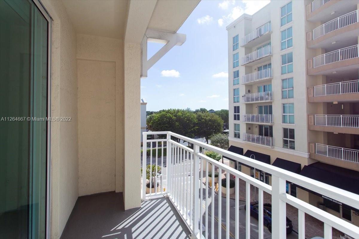 7275 Southwest 90th Street, Unit C310 Miami, FL 33156 - Photo 26 of 40 a view of a balcony with wooden floor
