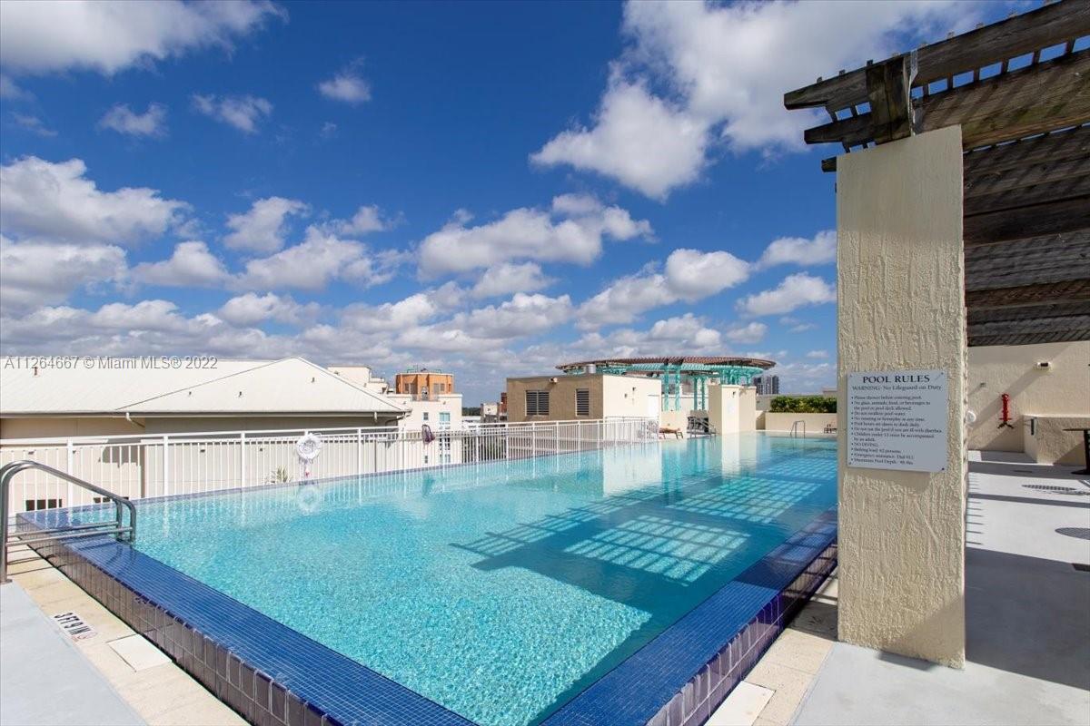 7275 Southwest 90th Street, Unit C310 Miami, FL 33156 - Photo 32 of 40 a view of a swimming pool with an outdoor seating