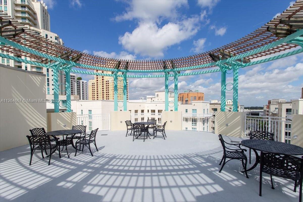 7275 Southwest 90th Street, Unit C310 Miami, FL 33156 - Photo 36 of 40 a view of a patio with table and chairs
