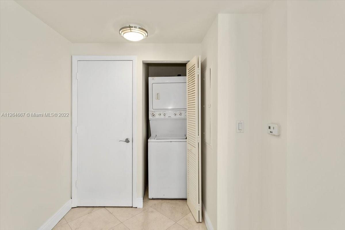 7275 Southwest 90th Street, Unit C310 Miami, FL 33156 - Photo 10 of 40 a view of an empty room with closet and a mirror
