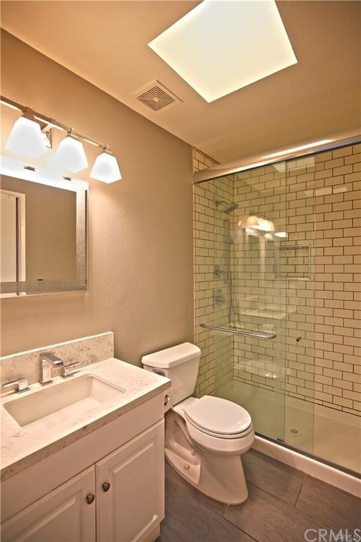105 East Beacon Street, Unit A Alhambra, CA 91801 - Photo 14 of 15 a bathroom with a toilet a sink and mirror