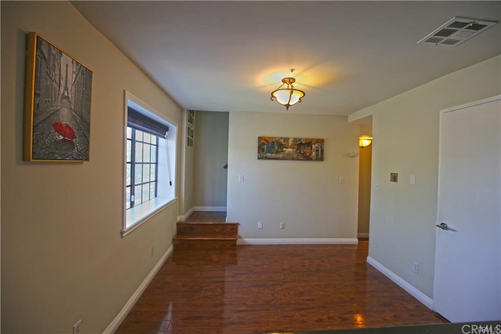 105 East Beacon Street, Unit A Alhambra, CA 91801 - Photo 7 of 15 wooden floor in an empty room with a window