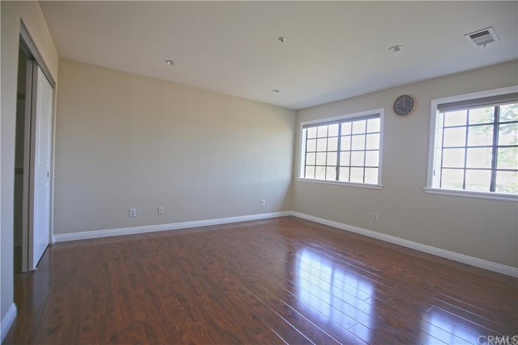 105 East Beacon Street, Unit A Alhambra, CA 91801 - Photo 10 of 15 an empty room with wooden floor and windows