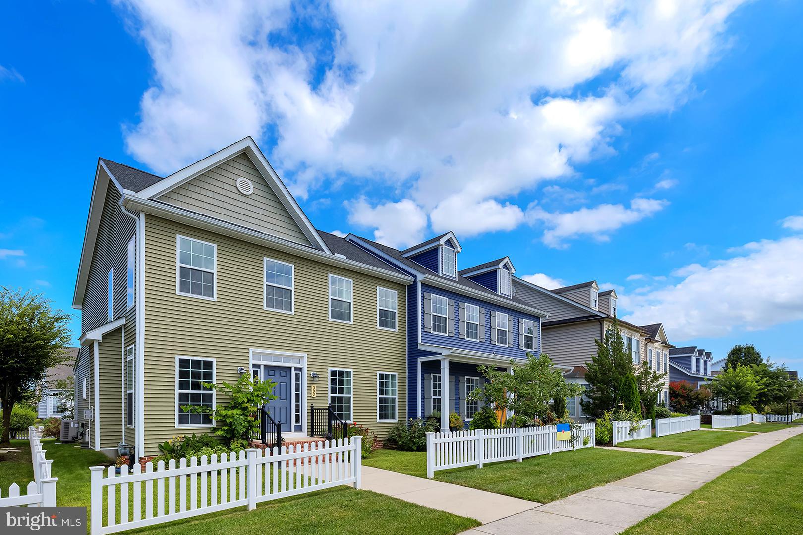 303 Brick Lane Milton, DE 19968 - Photo 2 of 71 a front view of a house with a yard