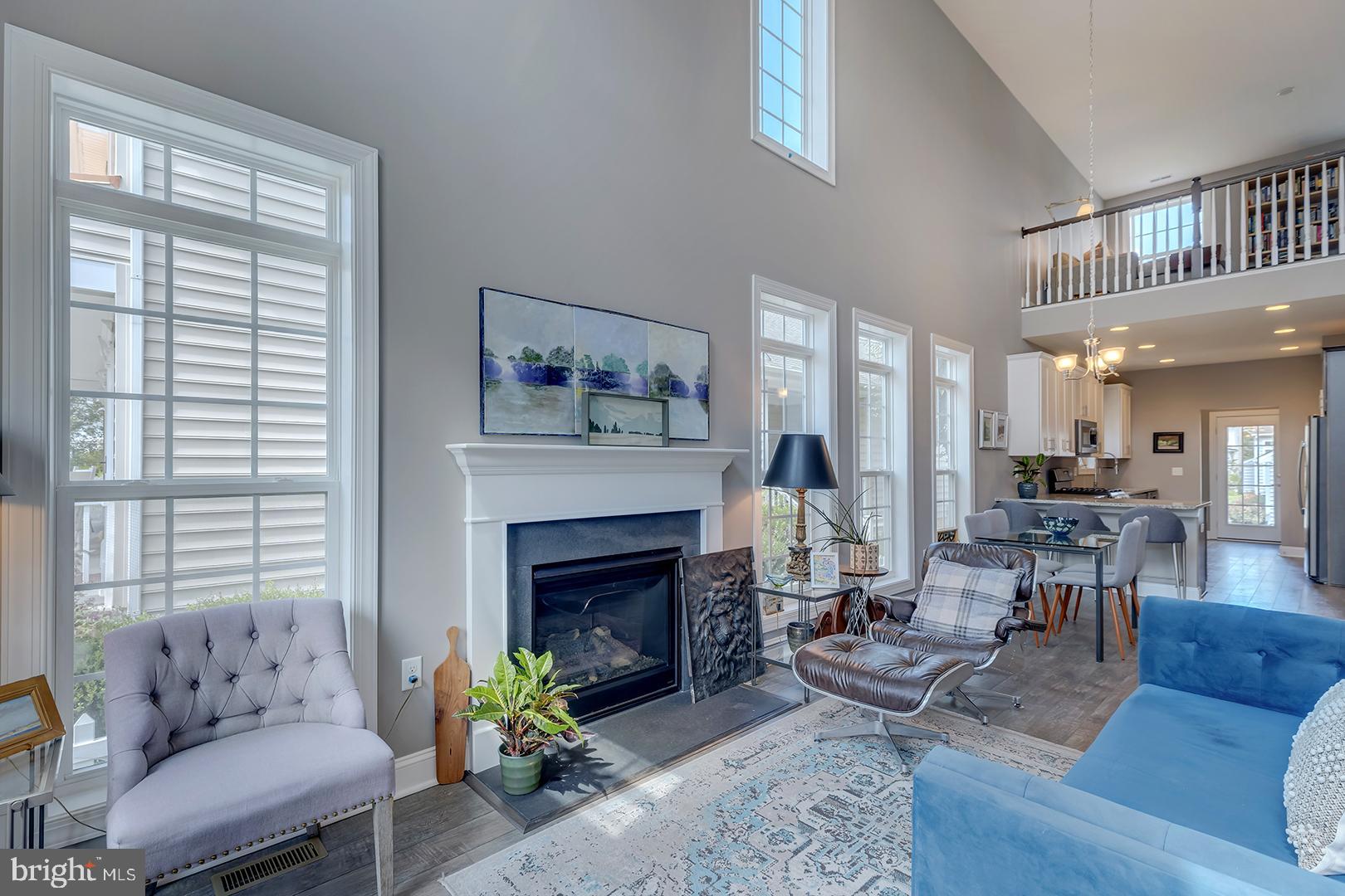 303 Brick Lane Milton, DE 19968 - Photo 21 of 71 a living room with furniture and a fireplace