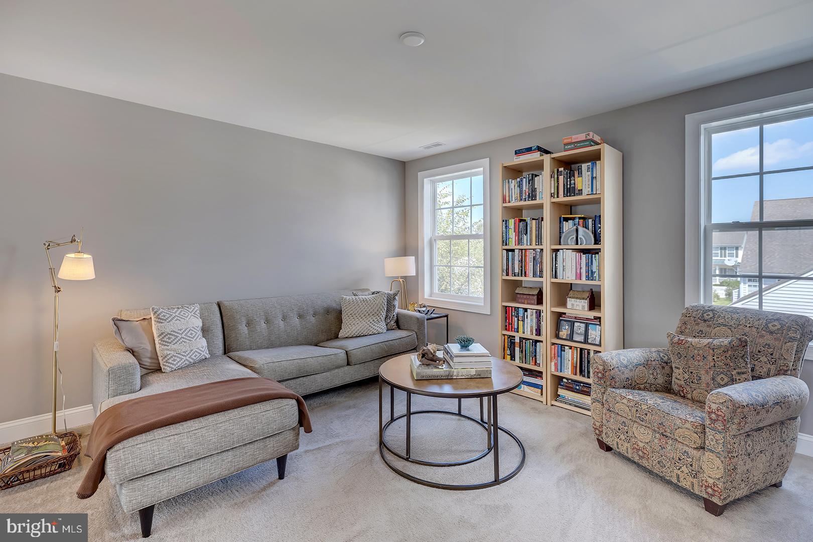 303 Brick Lane Milton, DE 19968 - Photo 23 of 71 a living room with furniture and a book shelf