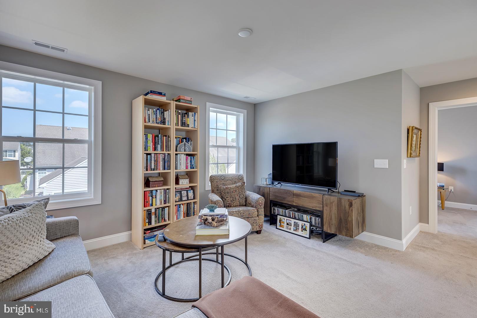 303 Brick Lane Milton, DE 19968 - Photo 24 of 71 a living room with furniture and a flat screen tv