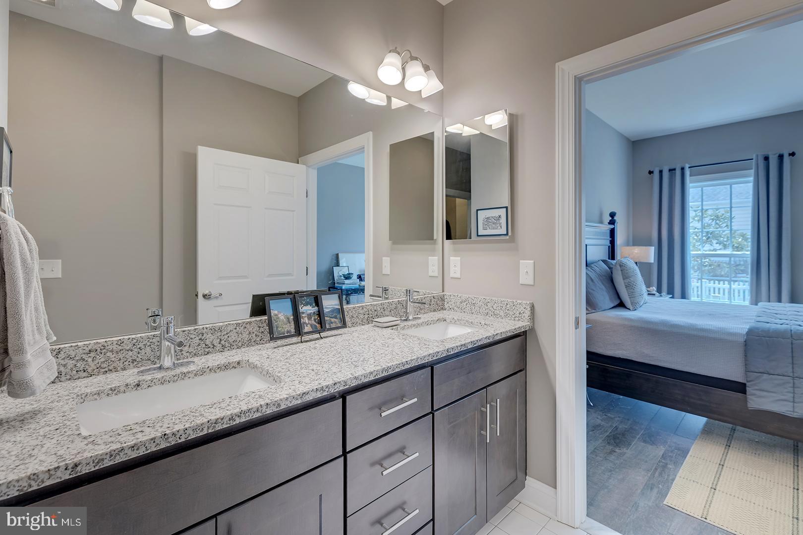 303 Brick Lane Milton, DE 19968 - Photo 31 of 71 a bathroom with a granite countertop double vanity sink and a large mirror
