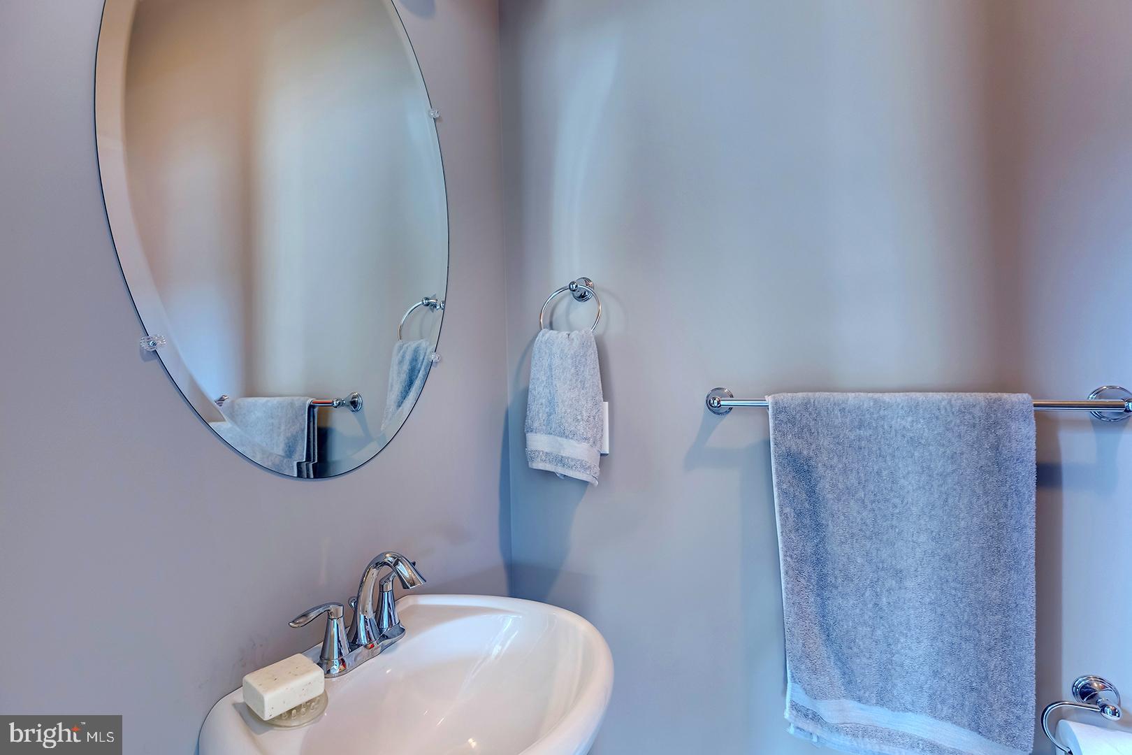 303 Brick Lane Milton, DE 19968 - Photo 33 of 71 a bathroom with a sink and mirror with toilet