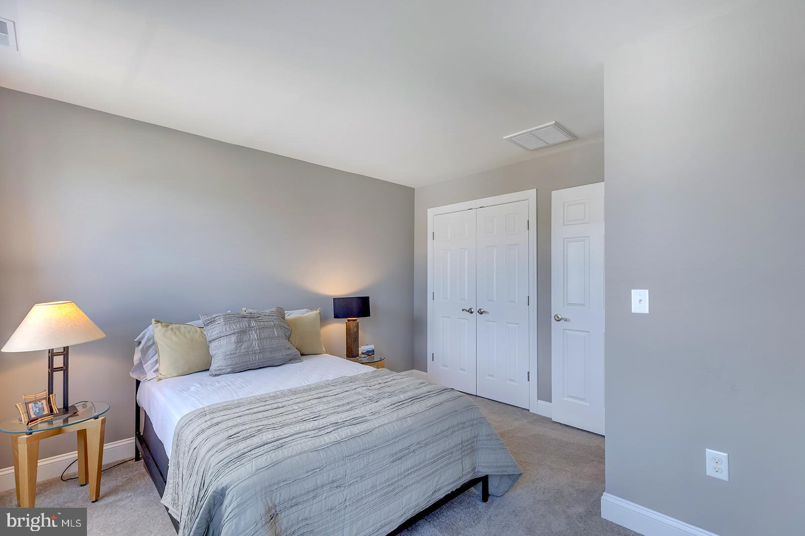 303 Brick Lane Milton, DE 19968 - Photo 36 of 71 a bedroom with a bed and a lamp