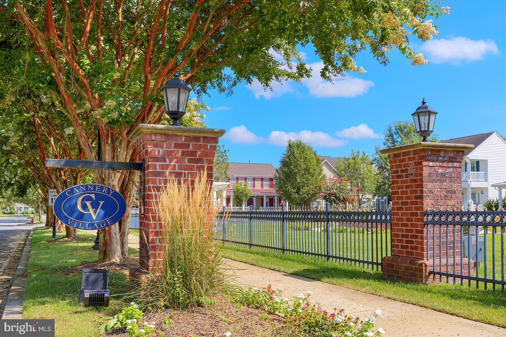 303 Brick Lane Milton, DE 19968 - Photo 49 of 71 a sign board with a play ground in the back